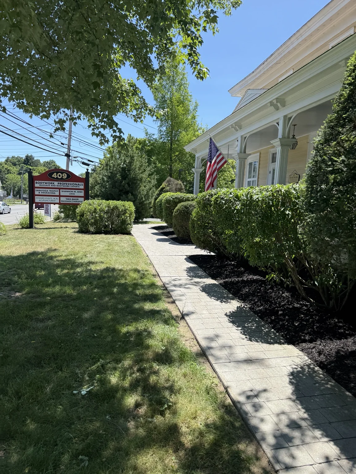 Commercial landscape refresh with fresh black mulch in Saratoga Springs