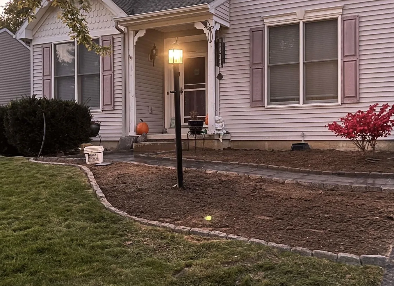 After paver walkway installation with stone border